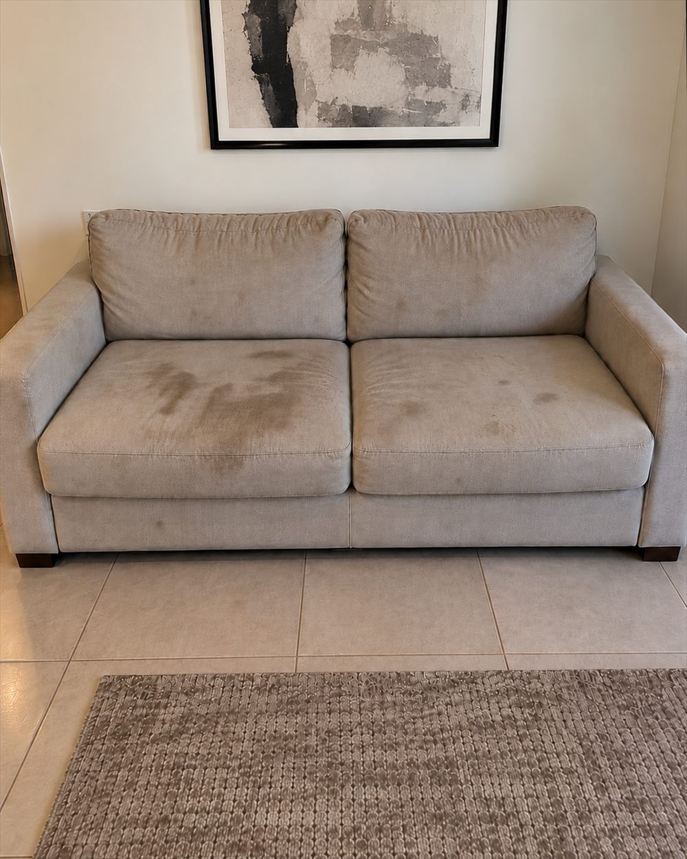 Sofa with stains and wear marks before cleaning